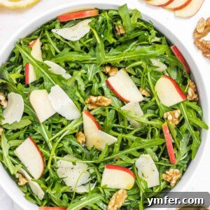 Arugula salad with walnuts and red apple