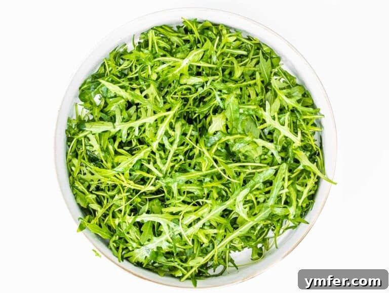 Rucola Rocket Greens with Citrus Vinaigrette 17 Arugula in a bowl being prepared for dressing
