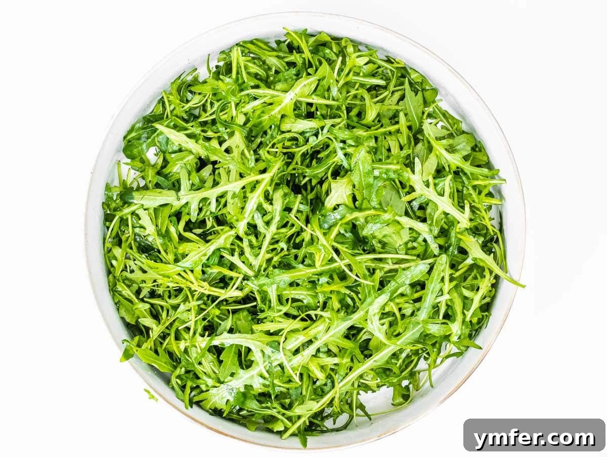 Rucola Rocket Greens with Citrus Vinaigrette 6 Arugula in a bowl being prepared for dressing