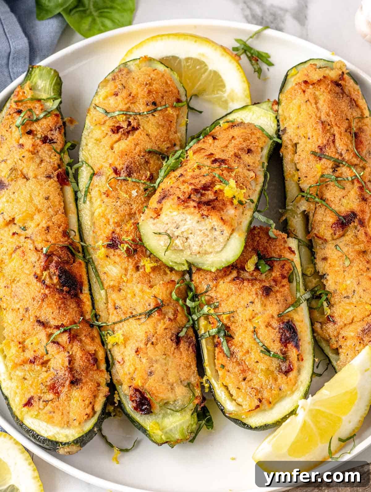 Stuffed zucchini ready to be served on a rustic wooden table.