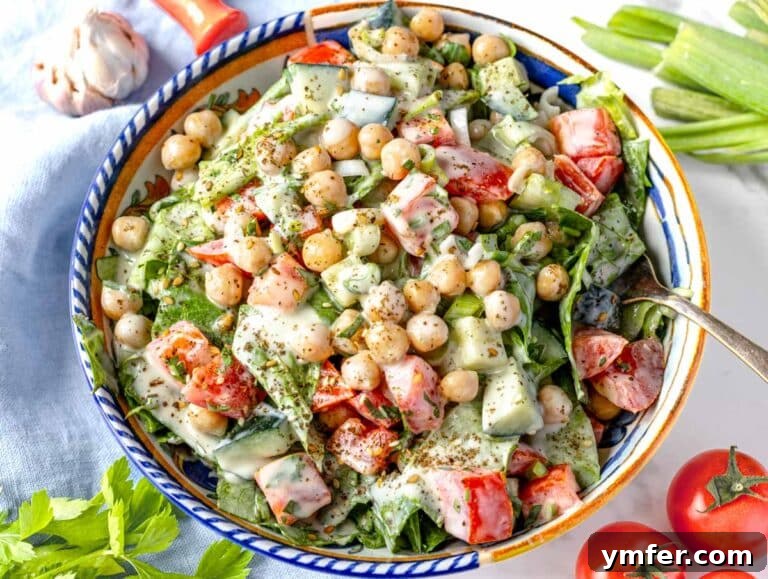 Zesty Tahini Salad 14 Tahini salad with chickpeas and cherry tomatoes in a bowl