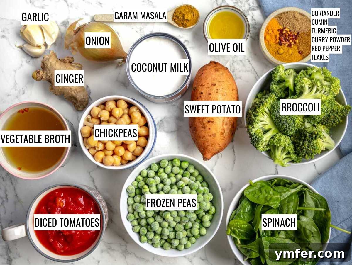 Vibrant Vegetable Curry 4 A flat lay of all raw ingredients needed for vegetable curry: olive oil, onion, garlic, ginger, various spices, sweet potato, broccoli, chickpeas, green peas, spinach, coconut milk, vegetable broth, and crushed tomatoes.