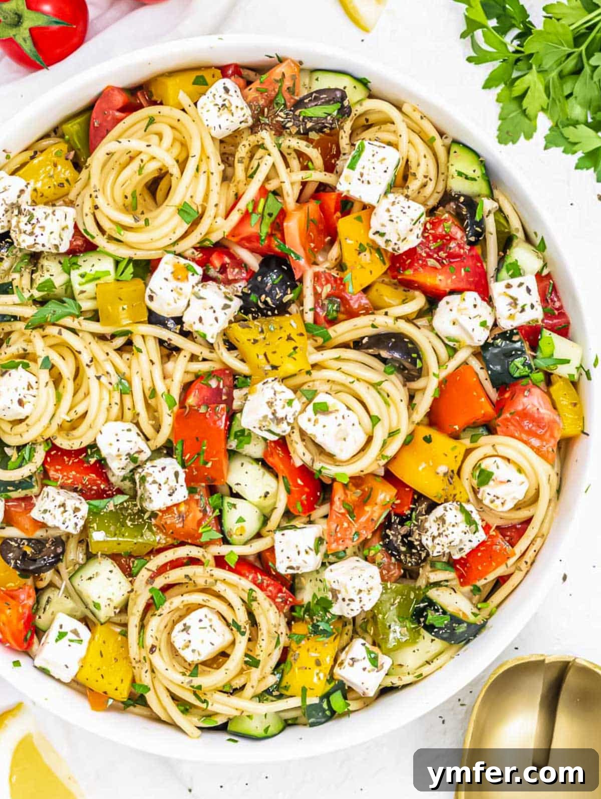 Vibrant Spaghetti Toss 2 A colorful and fresh spaghetti salad in a large bowl, ready to be served.