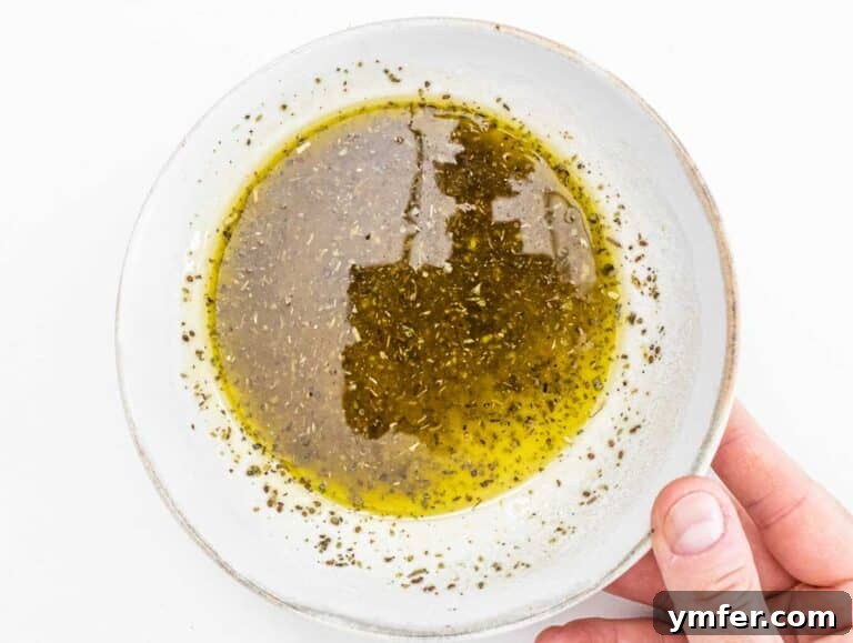 Vibrant Spaghetti Toss 6 A small bowl of homemade Italian dressing with lemon, herbs, and olive oil.