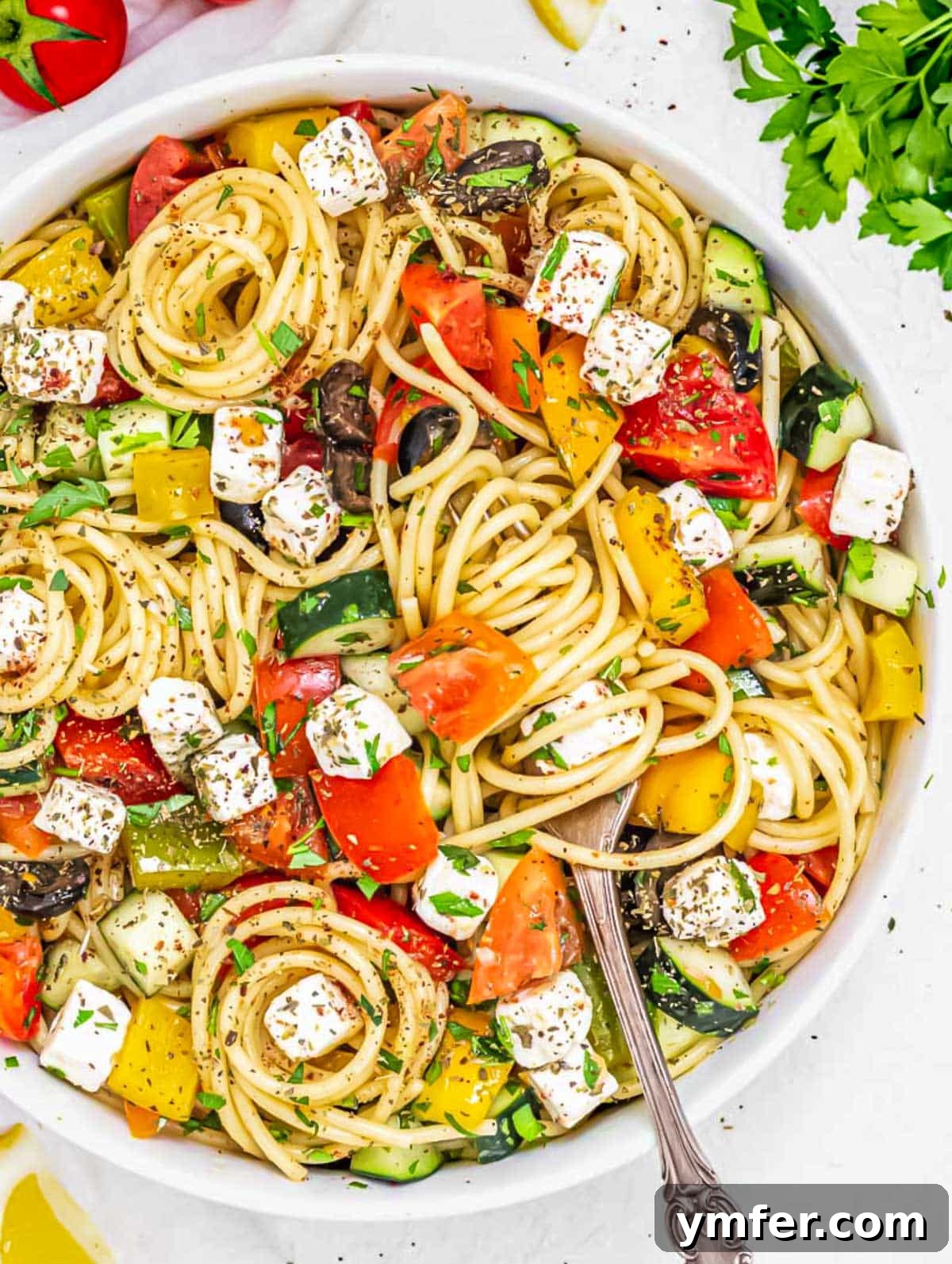 Vibrant Spaghetti Toss 3 Close-up of a cold spaghetti salad featuring colorful vegetables and a light dressing.