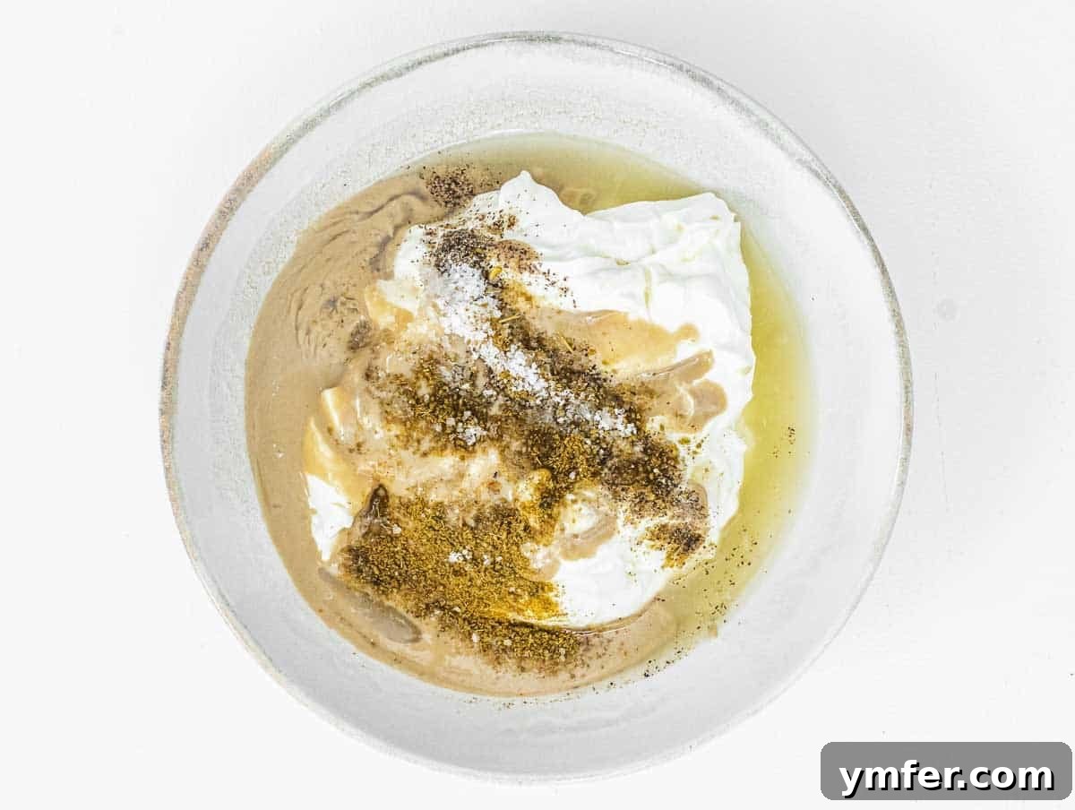 Creamy Tahini Yogurt Sauce 6 All wet and dry ingredients for Yogurt Tahini Dressing in a bowl before mixing