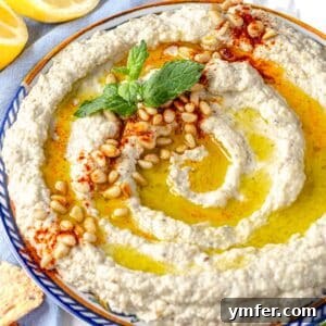 Smoky Eggplant Tahini Dip 11 Mutabal on a plate with fresh mint and toasted pine nuts