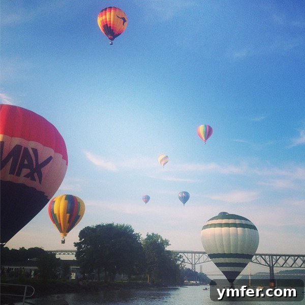 Colorful hot air balloons ascending over the Hudson River