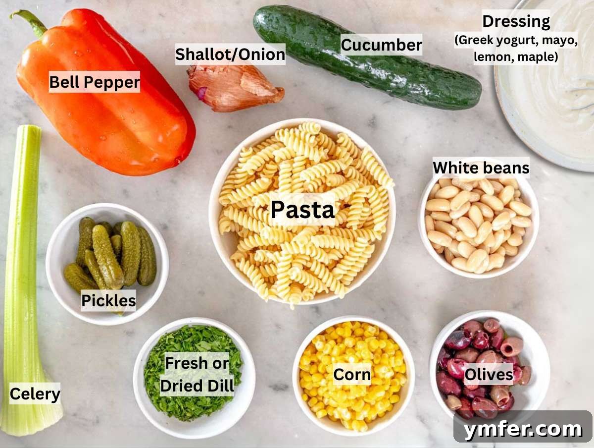 Velvety Pasta Salad 3 A flat lay image showing all the fresh ingredients laid out on a marble table for making creamy pasta salad.