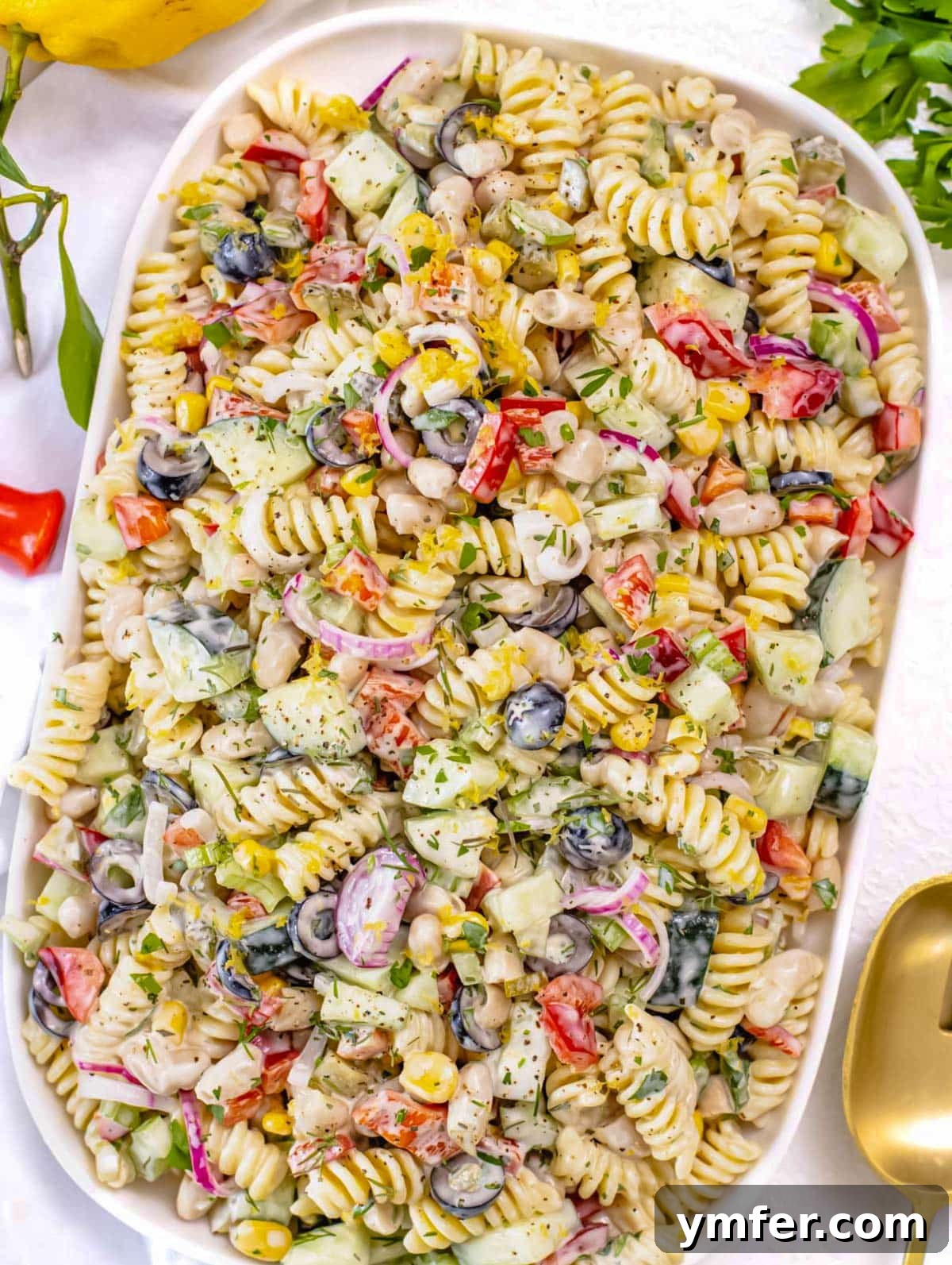 Velvety Pasta Salad 5 A close-up shot of creamy pasta salad in a bowl, showing the vibrant mix of pasta and vegetables coated in dressing.