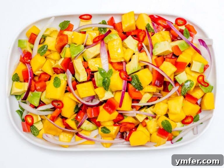 avocado, mange and red bell pepper in a bowl