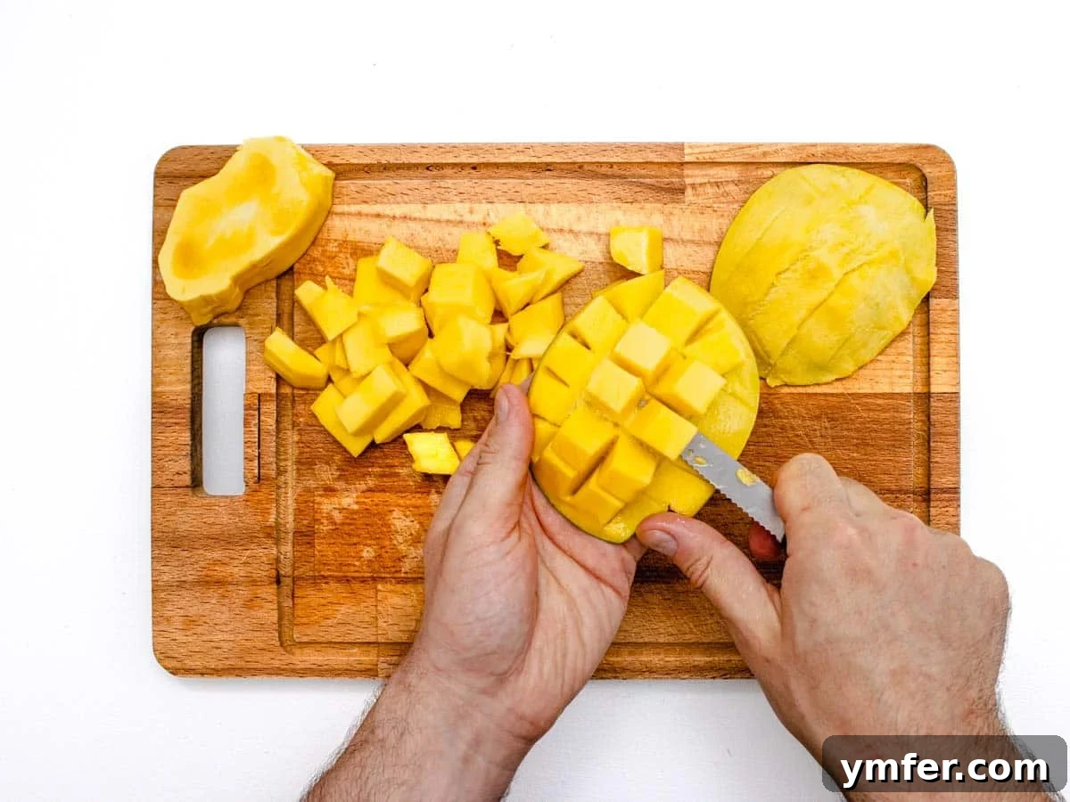 Tropical Mango Bliss 7 Removing diced mango from its peel