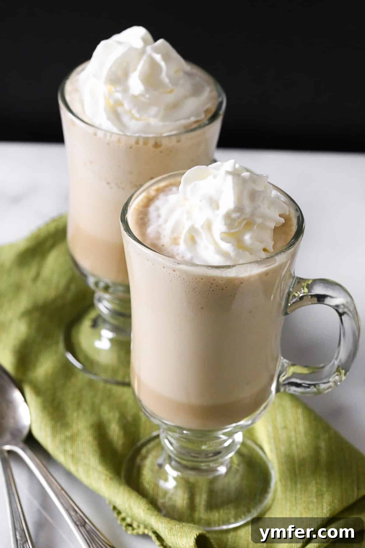 Spirited Coffee Chill 3 An Irish Coffee Frappe elegantly presented in a classic Irish coffee glass, showcasing its layers and creamy topping.