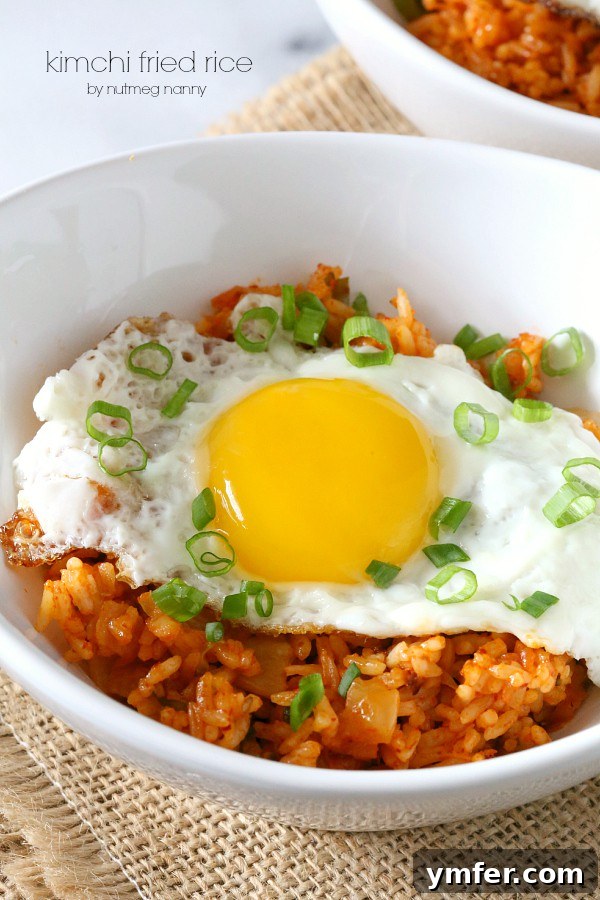 Kimchi Fried Rice by Nutmeg Nanny Kimchi Fried Rice topped with a fried egg, ready to be enjoyed.