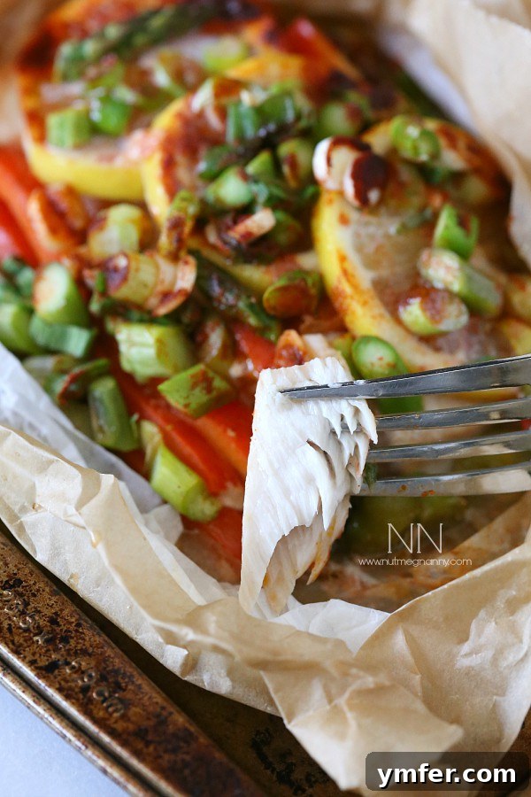 Mahi Mahi Flavor Parcels 5 Mahi Mahi En Papillote with a piece of fish on a fork.