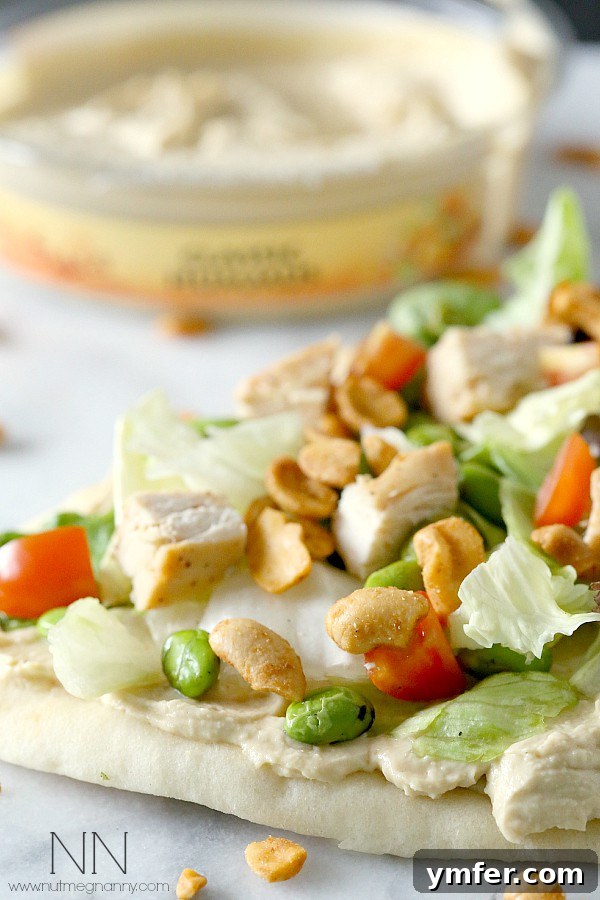 Vibrant Asian Hummus Flatbread 3 Close-up of Asian Salad Hummus Flatbread topped with dry roasted peanuts for crunch.