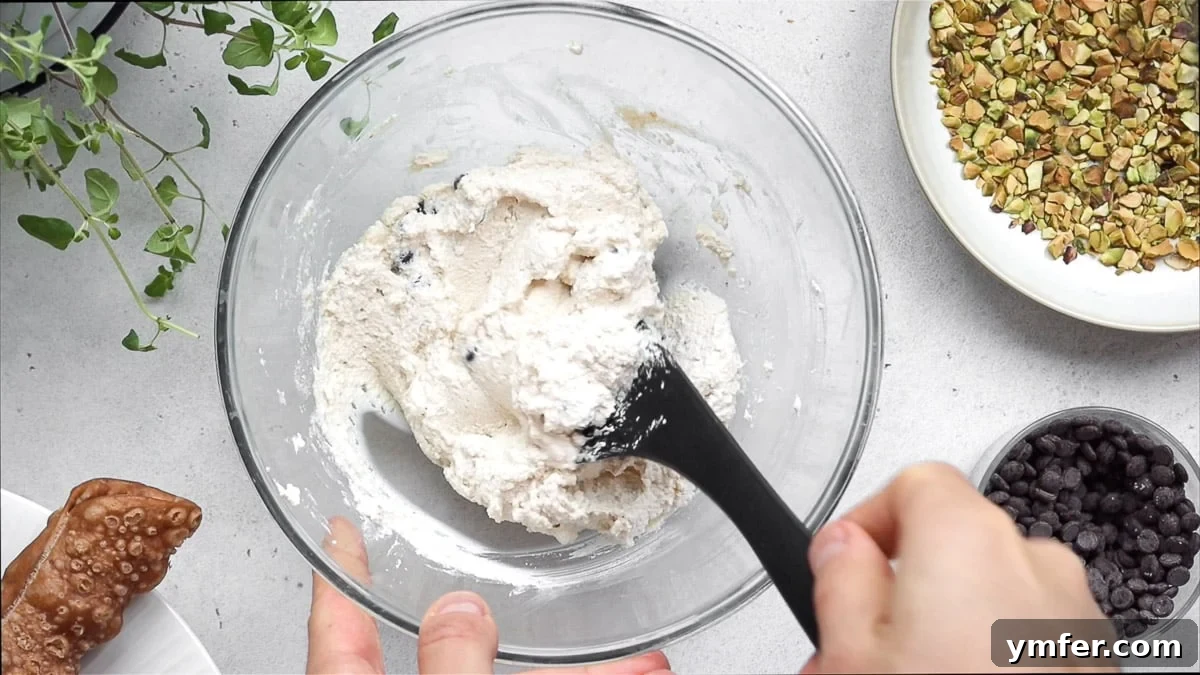Mixing the creamy vegan cannoli filling with chocolate chips and orange zest.