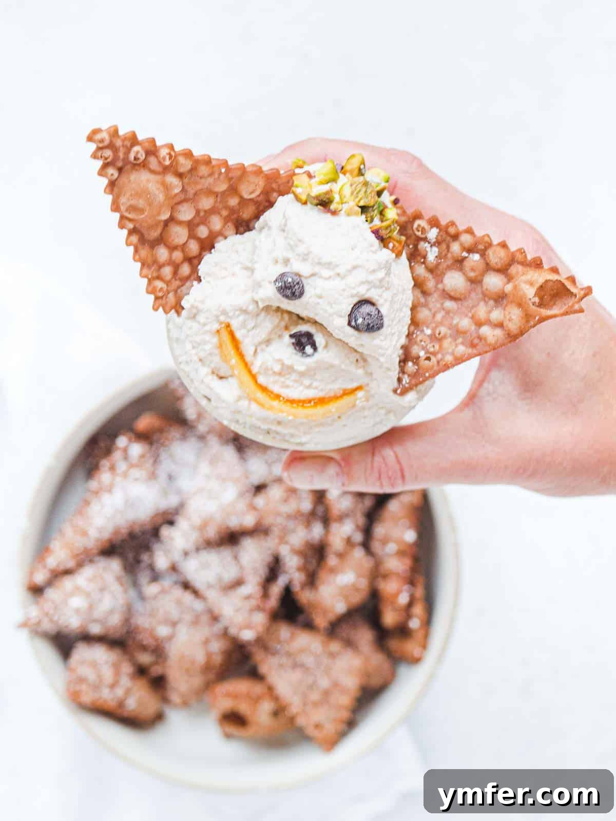 Crispy sweet nachos made from leftover cannoli dough, served with a side of creamy filling.
