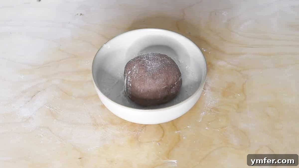Smooth dough ball resting after kneading for cannoli shells.