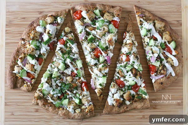 Greek Chicken Souvlaki Pizza 3 Chicken Souvlaki Pizza sliced on a wooden board, ready to serve.