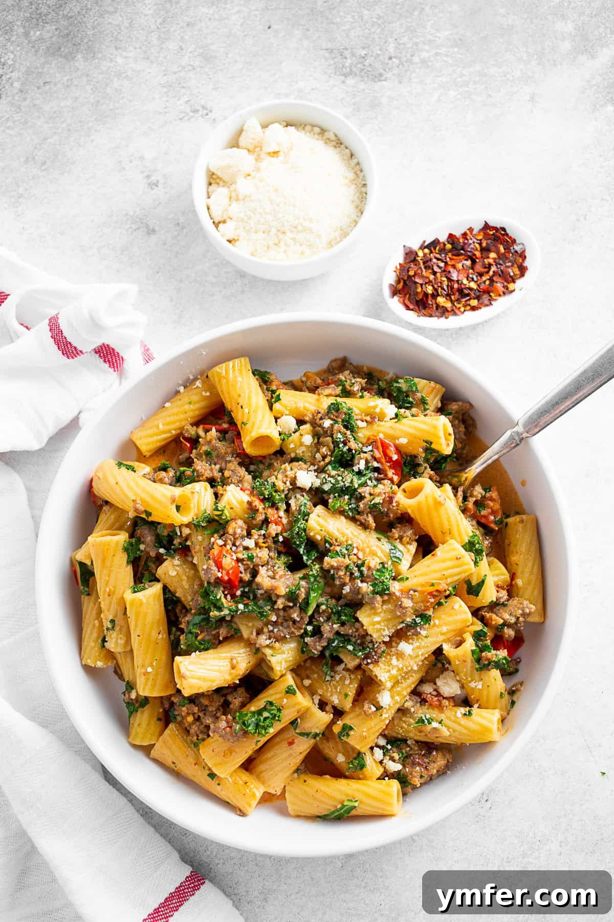 Italian Sausage Kale Pasta served with Parmesan cheese. 