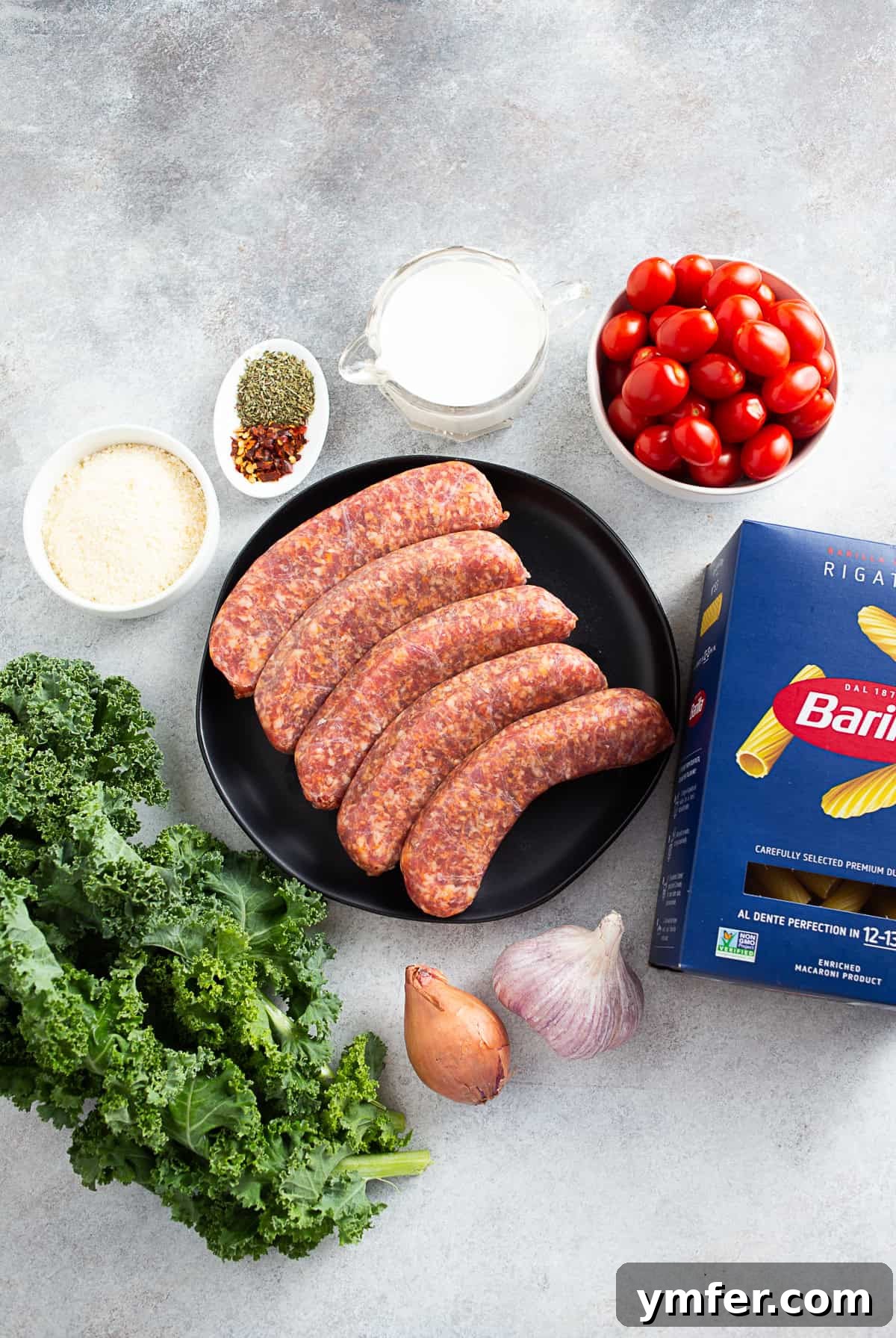 Uncooked ingredients for Italian Sausage Kale Pasta on a table. 