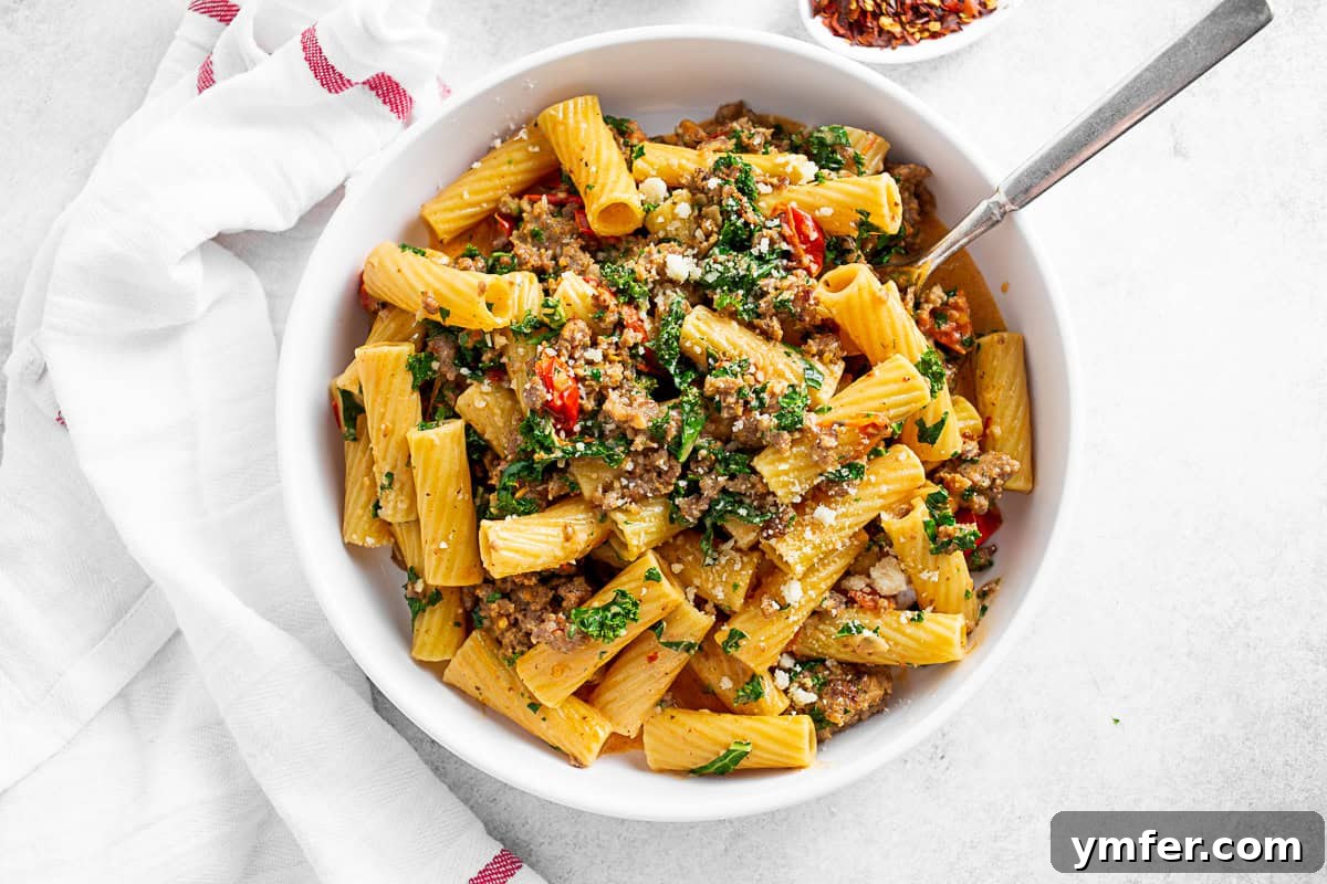 Italian Sausage Kale Pasta served with a napkin and fork. 