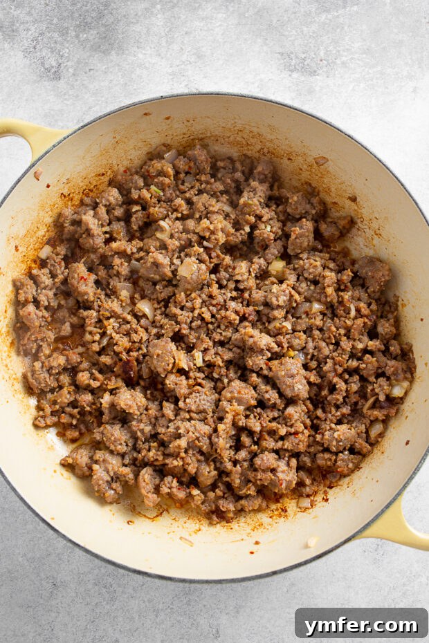 Browned Italian sausage in a skillet. 