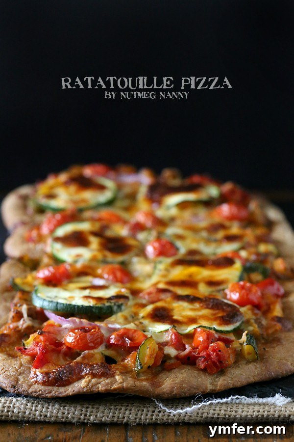 Provencal Garden Pizza 2 A vibrant Ratatouille Pizza, generously topped with colorful vegetables and melted mozzarella, resting on a wooden board ready to be served.