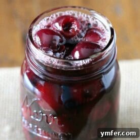 pickled cherries in a glass quart jar