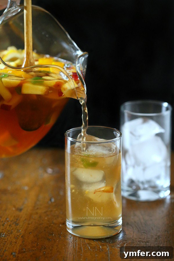 Spicy Hibiscus Peach Tea Sangria served in glasses with fresh fruit and ice