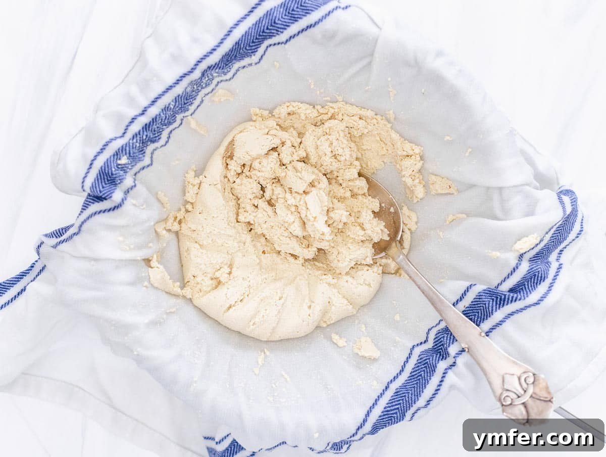Creamy Vegan Ricotta 13 Freshly drained curdled milk, removed from the cloth, revealing the soft, textured vegan ricotta.