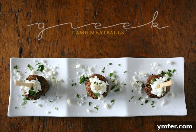 Greek Lamb Meatballs served with Tzatziki Greek Lamb Meatballs on a serving tray, garnished with fresh herbs.