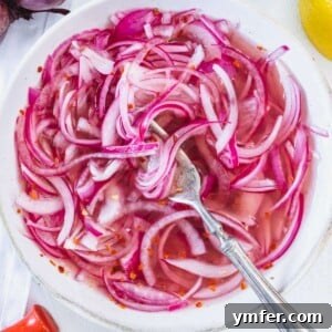 Pickled red onions in a white bowl