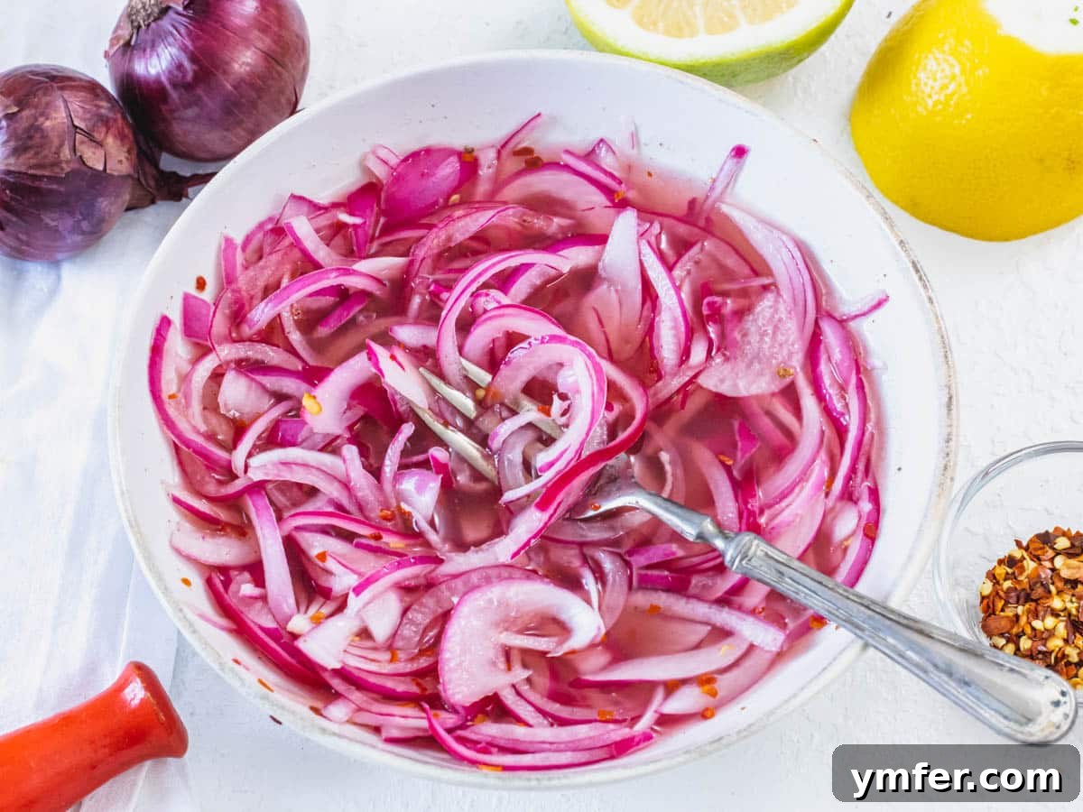 Pickled red onions in a white bowl