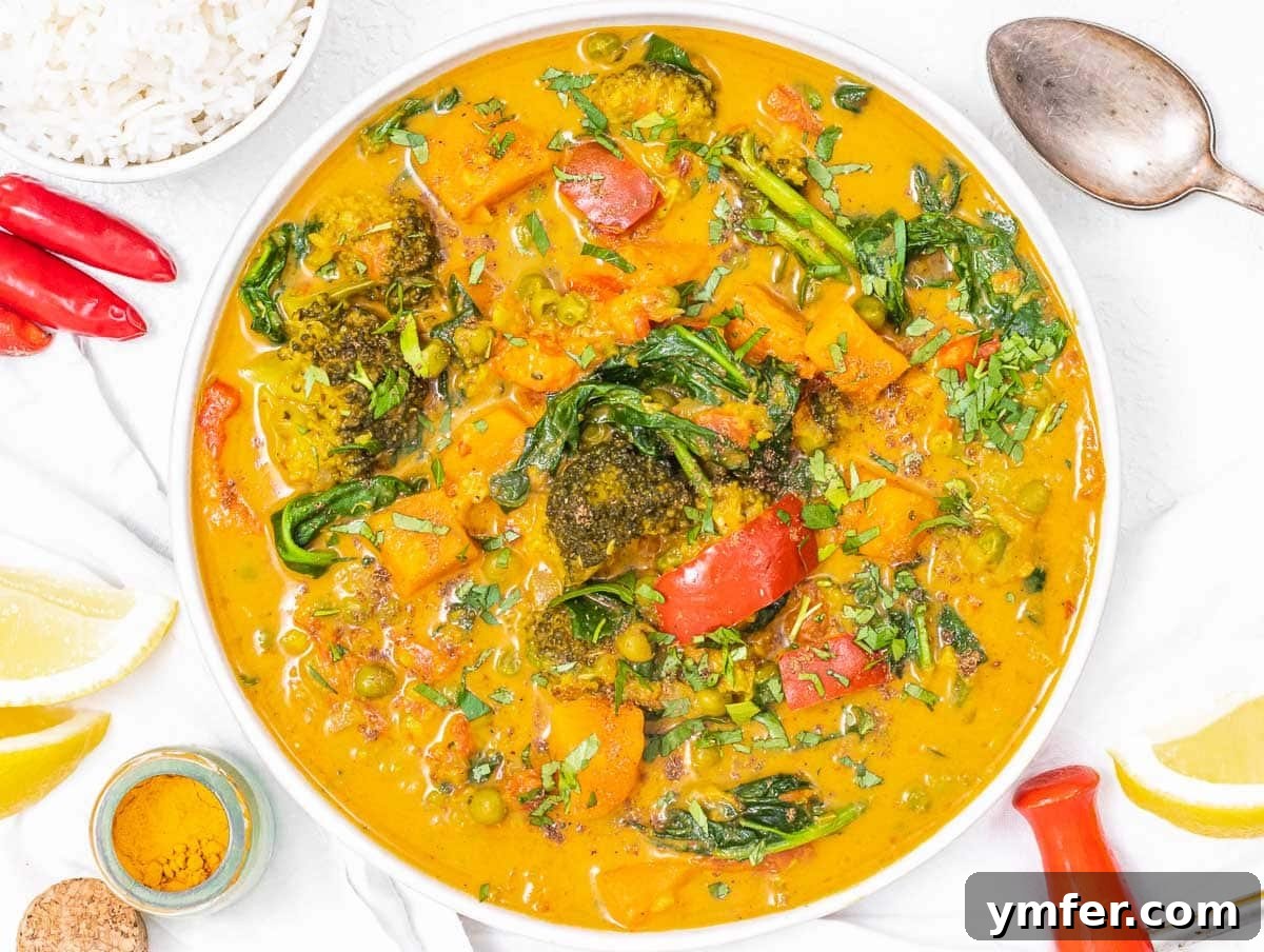 Nourishing Plant Power Meals 30 Vibrant vegetable curry garnished with a fresh lemon wedge