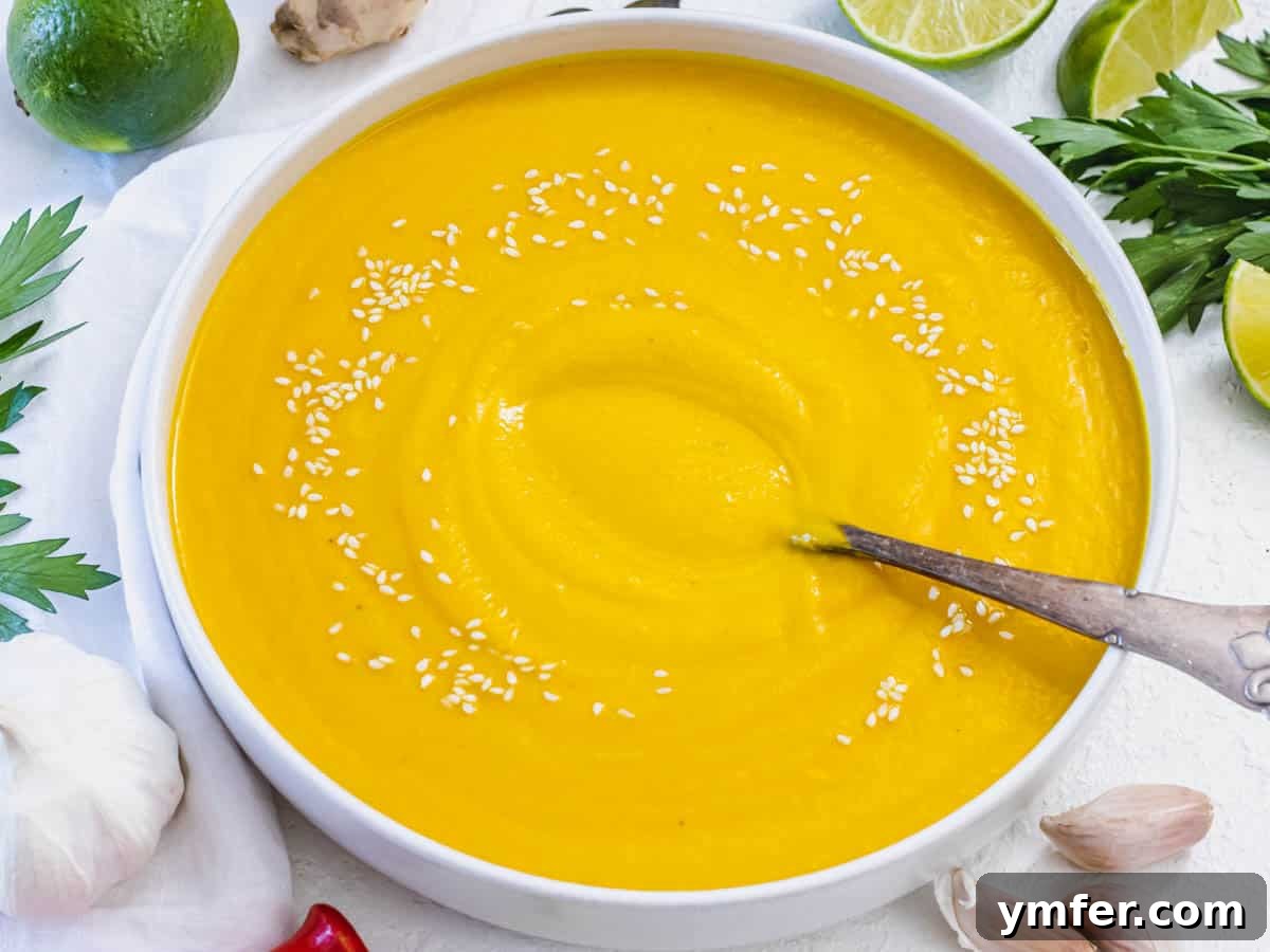 Nourishing Plant Power Meals 4 Creamy Kabocha squash soup garnished with sesame seeds and a silver spoon