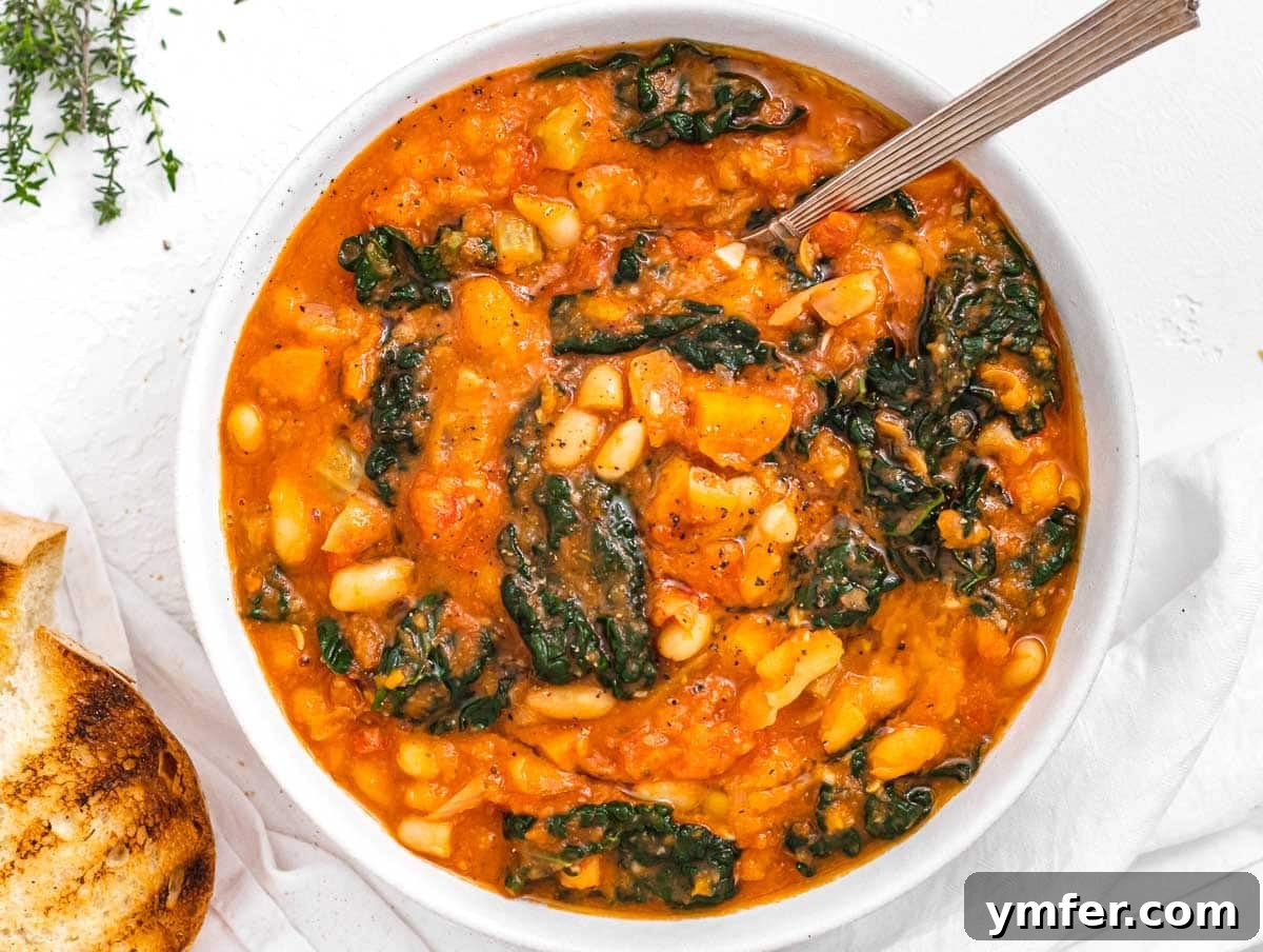 Nourishing Plant Power Meals 31 Nourishing kale soup served in a bowl with a spoon and fresh bread