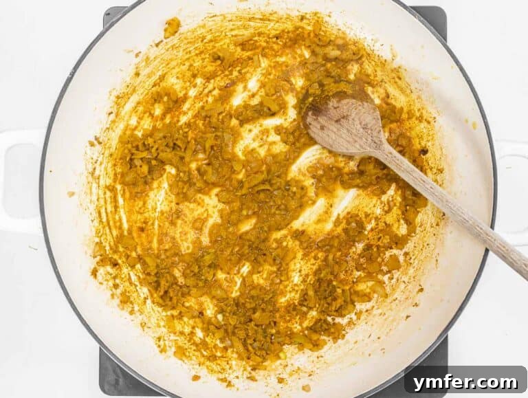 Nourishing Plant Power Meals 36 Aromatic spice mix roasting in a skillet with onions, garlic, and ginger