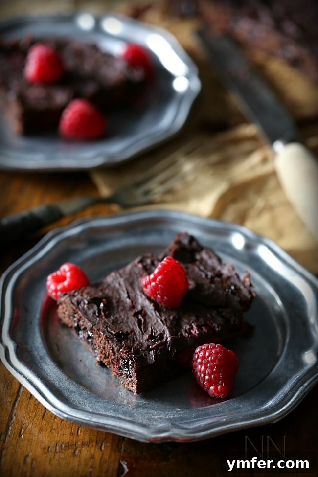 Achieving the Perfect Fudgy Brownie Texture Closeup of fudgy raspberry chipotle black bean brownies, highlighting their dense and moist texture.