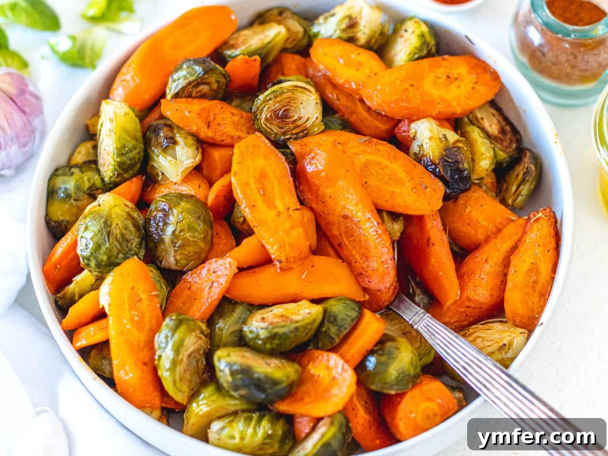 Caramelized Carrots and Crispy Brussels Sprouts 11 Roasted carrots and Brussels sprouts with a spoon, sprinkled with paprika and fresh herbs.