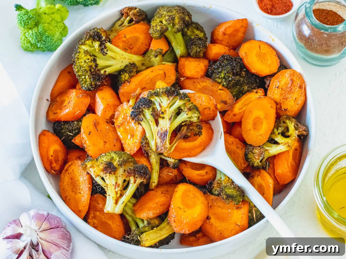 Caramelized Carrots and Crispy Brussels Sprouts 12 A bowl of roasted carrots and broccoli florets, garnished.