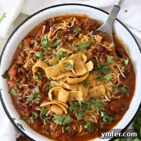 Cozy Slow Cooker Pumpkin Chili 2 This slow cooker pumpkin chili is packed full of pumpkin puree, spicy Italian sausage and lots of beans and vegetables. This hearty soup is perfect for cold winter nights.