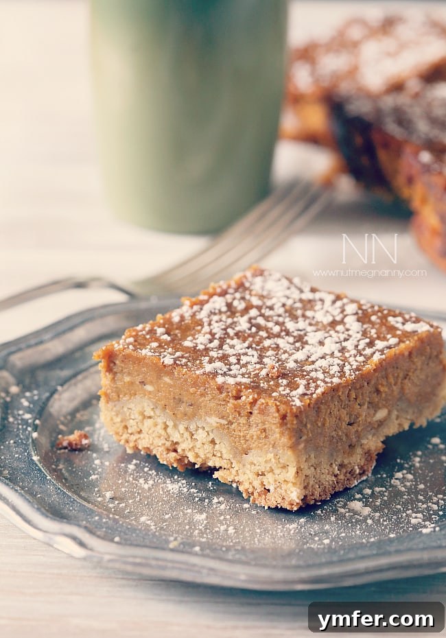 Moist Pumpkin Pie Cake Bars ready to be devoured, a delightful autumn dessert. Close-up of a Pumpkin Pie Cake Bar on a plate, with more sliced bars visible in the background, showing the thick, creamy pumpkin layer.