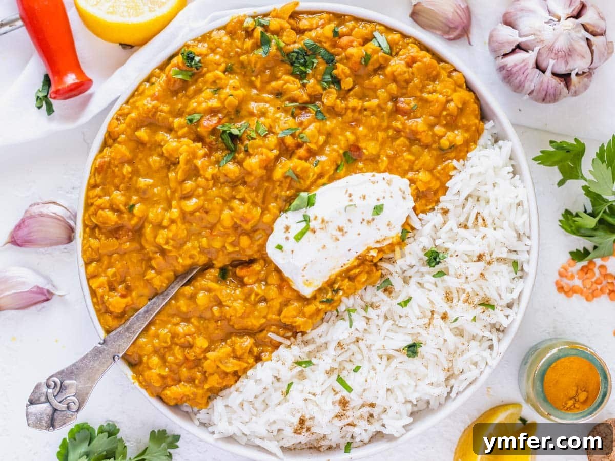 Streamline Your Week with Vegetarian Meal Prep 17 Warm lentil curry served alongside fluffy rice and a dollop of plant-based yogurt, a comforting and freezer-friendly meal prep idea.