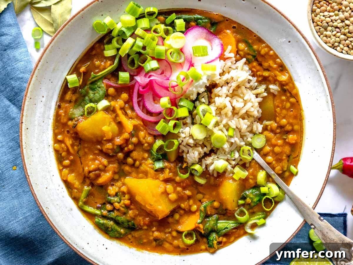 Streamline Your Week with Vegetarian Meal Prep 21 Hearty curry lentil soup served in a handcrafted white bowl, a warm and comforting meal prep option.
