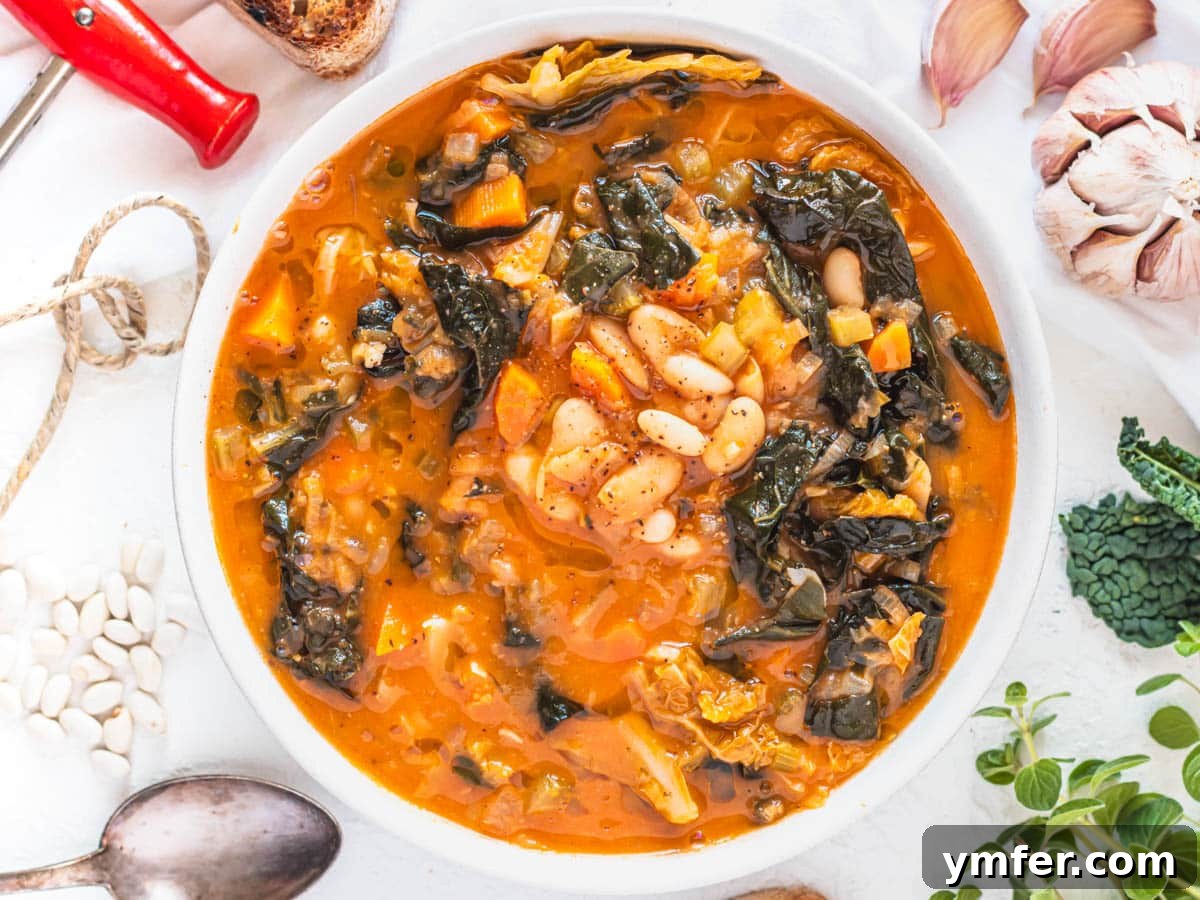 Streamline Your Week with Vegetarian Meal Prep 23 Rustic Tuscan white bean soup adorned with leafy greens and fresh herbs, presented as a comforting meal.