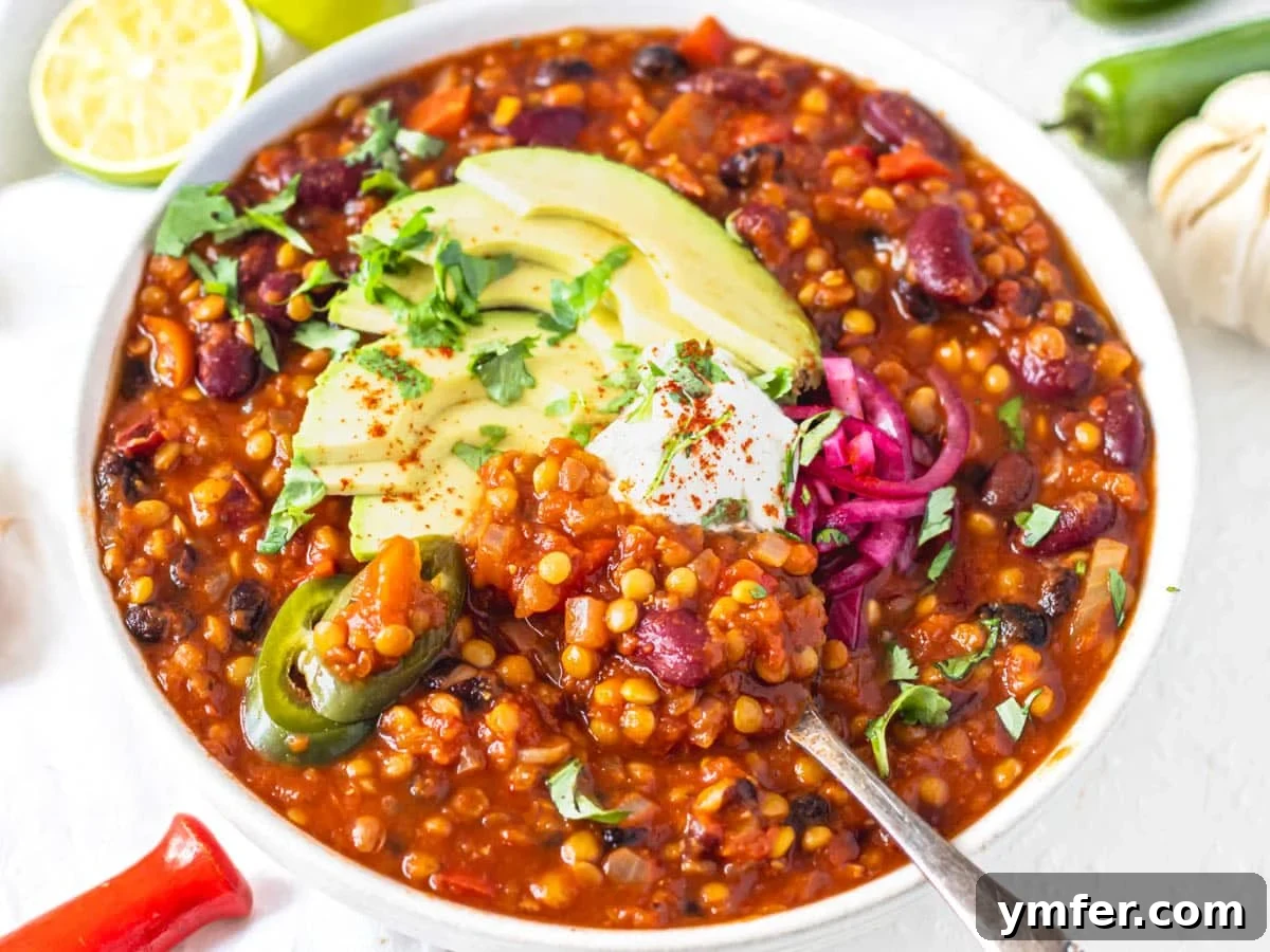 Streamline Your Week with Vegetarian Meal Prep 27 Hearty lentil chili topped with sour cream, avocado, and pickled red onions, a protein-packed alternative for meal prep.