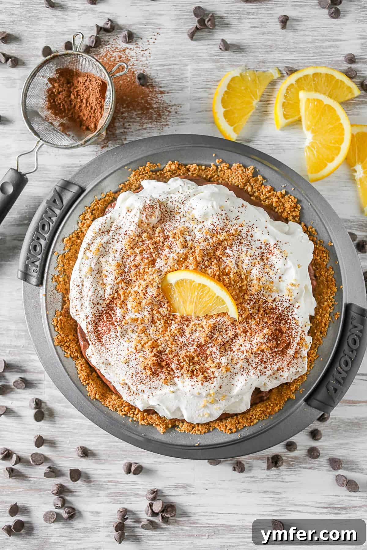 This super simple chocolate orange pudding pie is a breeze to make! Crazy delicious and packed into a pretzel crust. It's the prefect sweet and salty bite! Chocolate Orange Pudding Pie uncut in the pie dish.