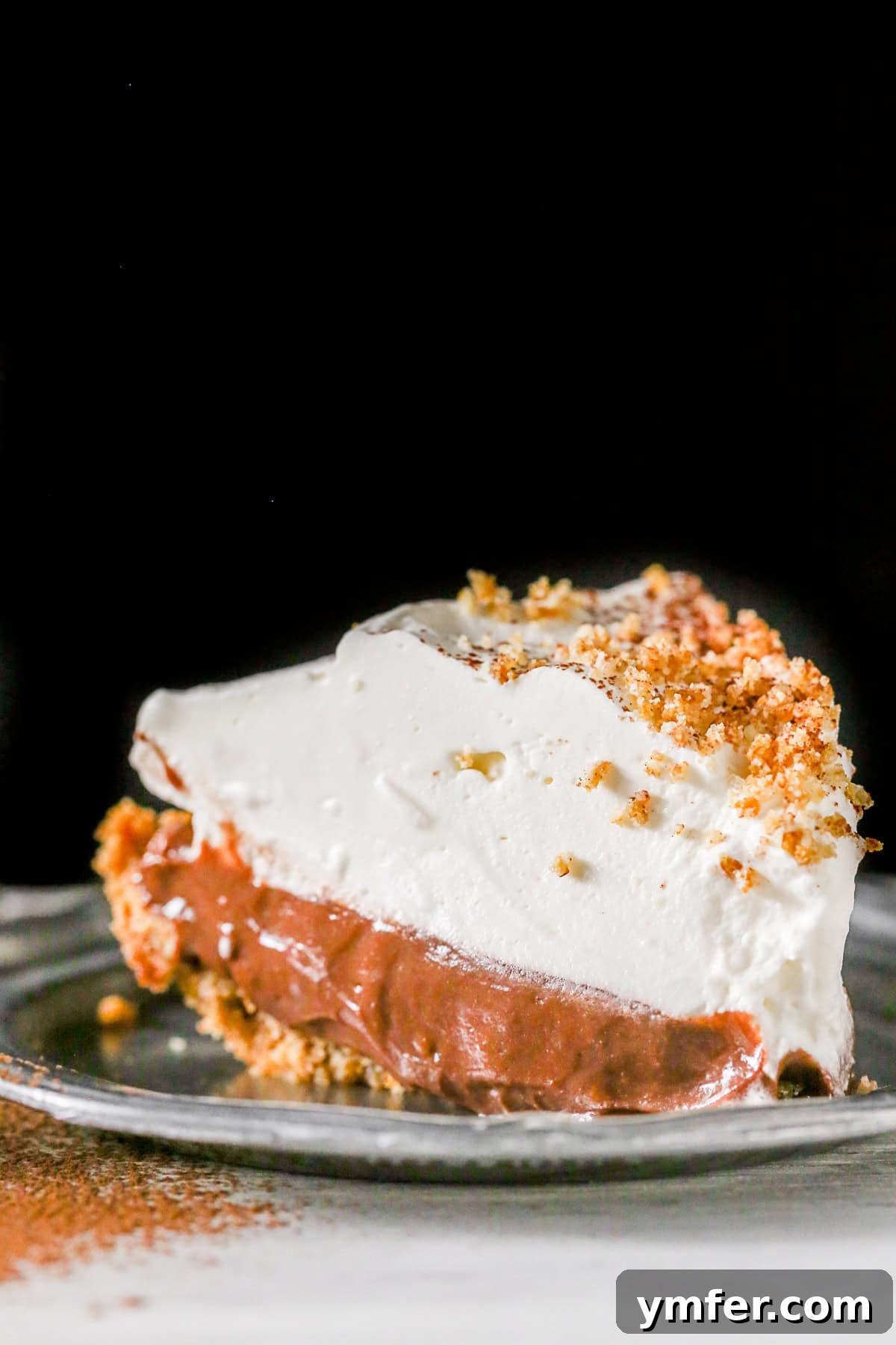 Sun-Kissed Chocolate Orange Delight 2 Chocolate Orange Pudding Pie sliced on a small plate.